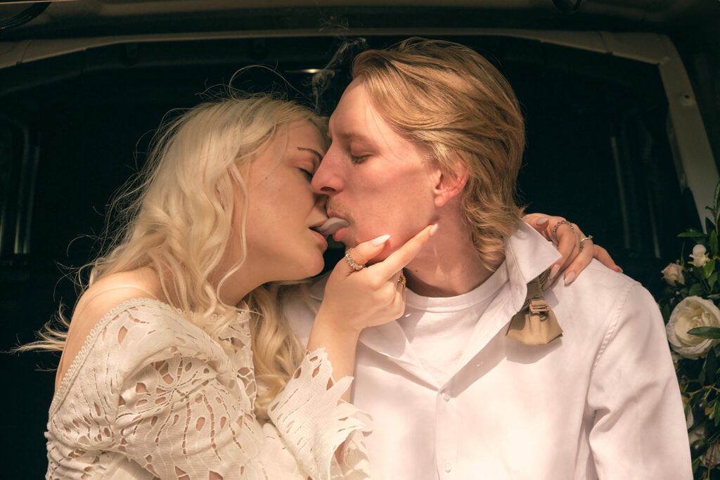 a newly wed couple relax by sharing a hit during their washington elopement