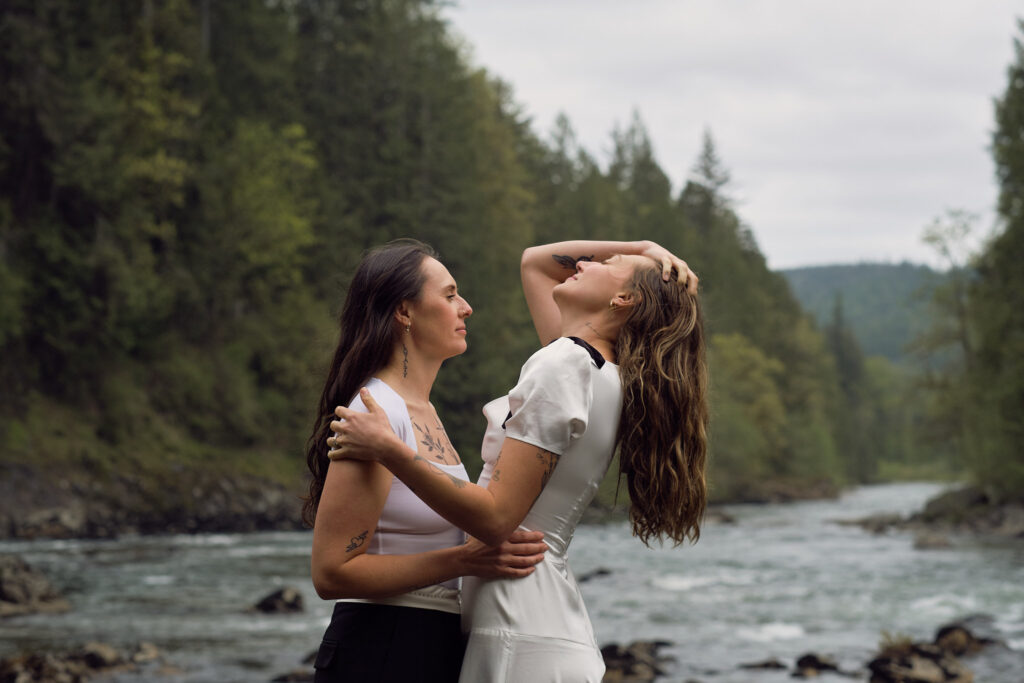 two brides enjoy the view of their Washington waterfall elopement