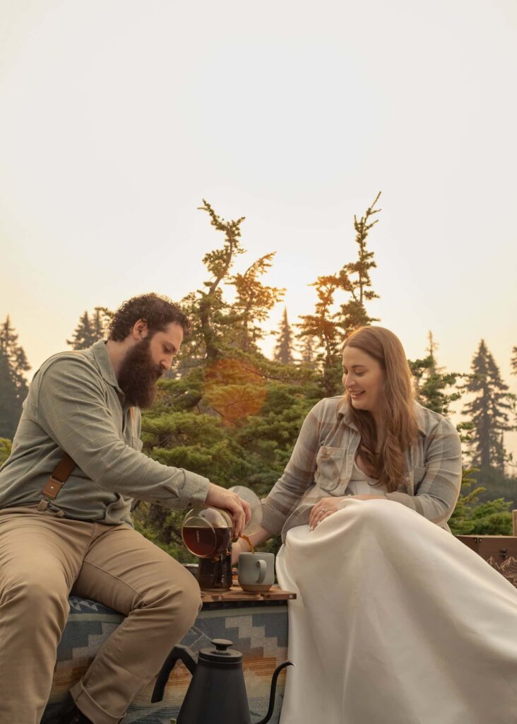 a bride and groom pour coffee for their picnic