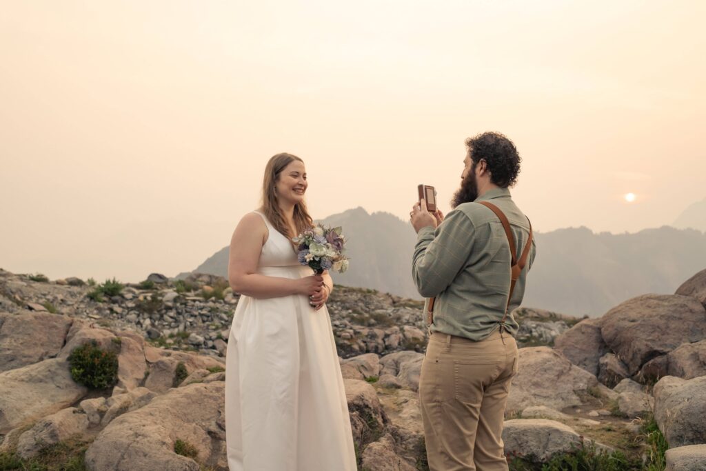 a groom takes a polaroid of his bride